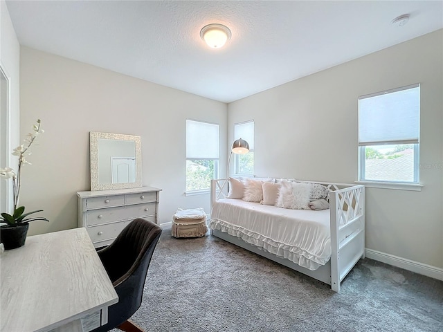 carpeted bedroom featuring a textured ceiling