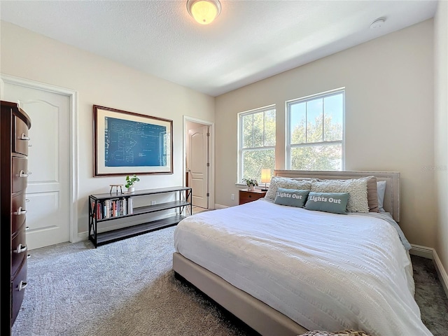 carpeted bedroom featuring a textured ceiling