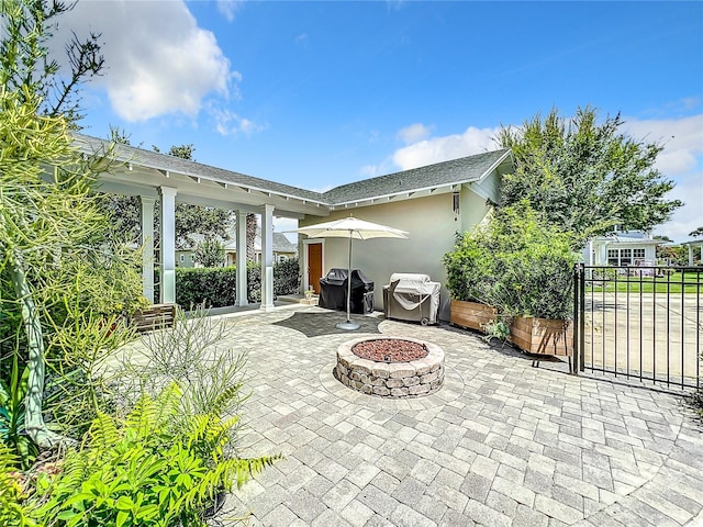 view of patio / terrace featuring a grill and an outdoor fire pit