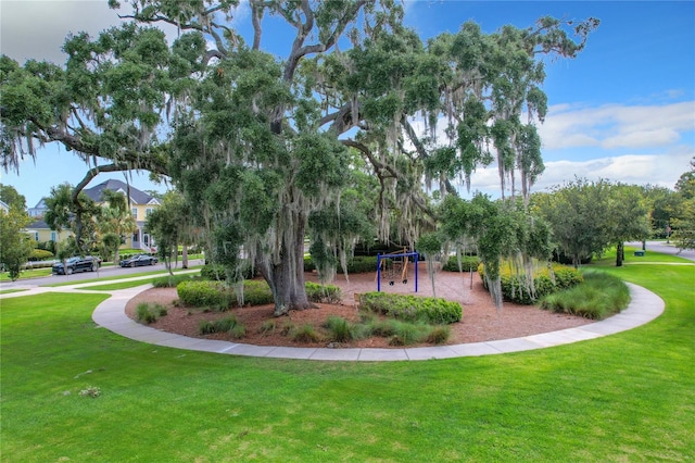 view of community with a lawn and a playground