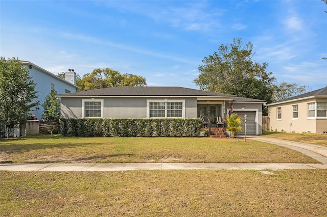 ranch-style home featuring a garage and a front yard