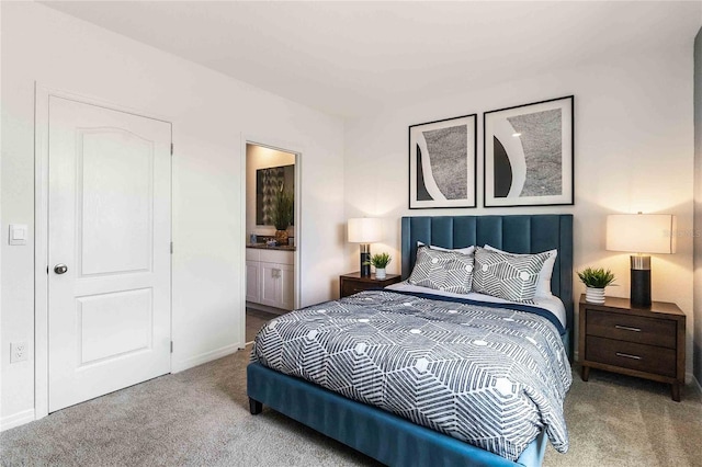 bedroom featuring light colored carpet and connected bathroom