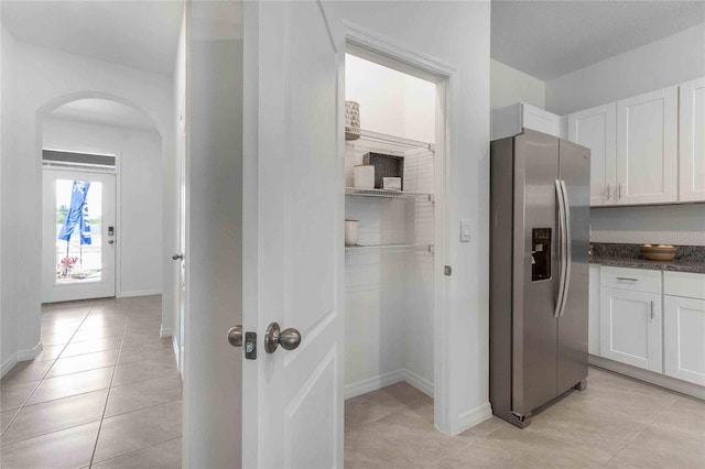 hall featuring light tile patterned floors