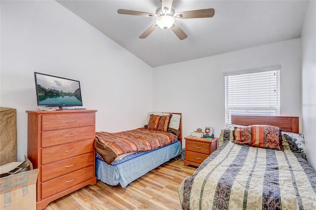 bedroom featuring ceiling fan, lofted ceiling, and light hardwood / wood-style flooring