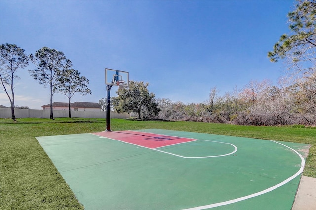 view of sport court with a yard