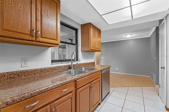 kitchen featuring light tile patterned flooring, dishwasher, sink, dark stone counters, and ornamental molding