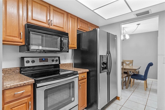 kitchen featuring stainless steel appliances and light tile patterned floors