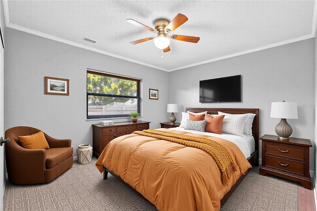 carpeted bedroom featuring ceiling fan, ornamental molding, and a textured ceiling