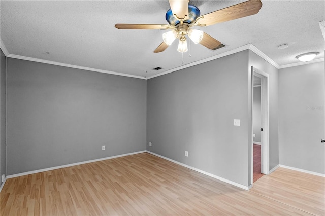 empty room featuring crown molding, ceiling fan, a textured ceiling, and light hardwood / wood-style flooring