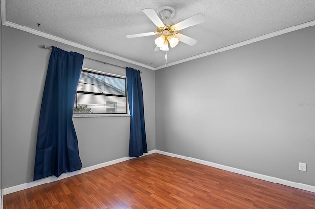 empty room with wood-type flooring, ornamental molding, a textured ceiling, and ceiling fan