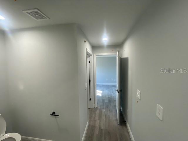 hallway with wood-type flooring