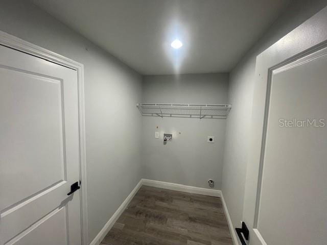 laundry area featuring dark wood-type flooring, hookup for a washing machine, and electric dryer hookup