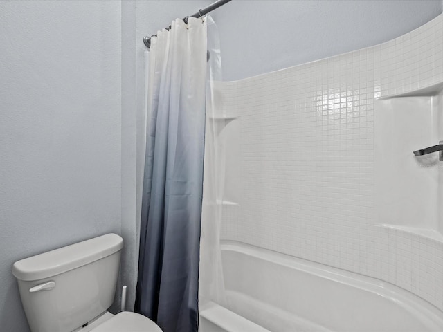 bathroom featuring toilet and shower / bath combo with shower curtain