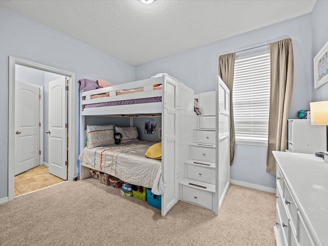 carpeted bedroom featuring multiple windows and a textured ceiling