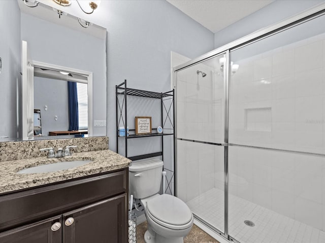 bathroom featuring walk in shower, vanity, and toilet