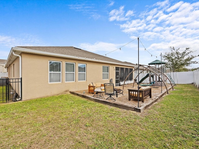 back of property with a playground and a lawn