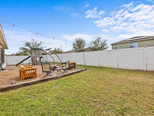 view of yard featuring a playground and a fire pit