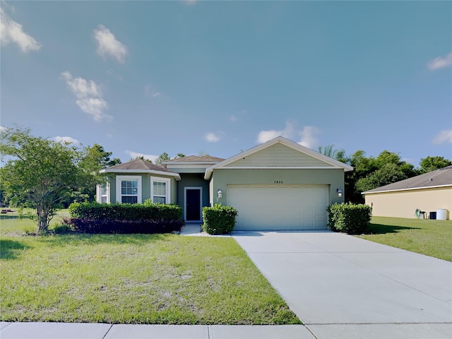 ranch-style house with a garage and a front yard