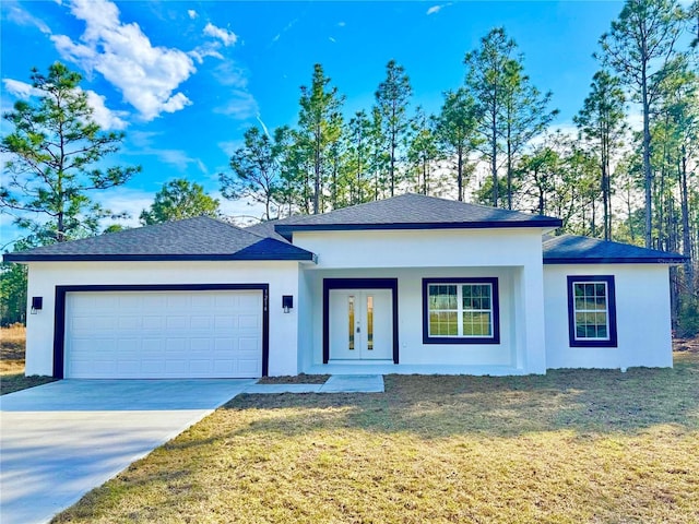 view of front of property with a garage and a front yard