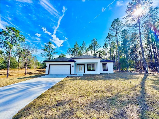 view of front of house with a garage and a front lawn