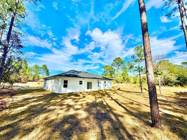 view of property exterior with a lawn