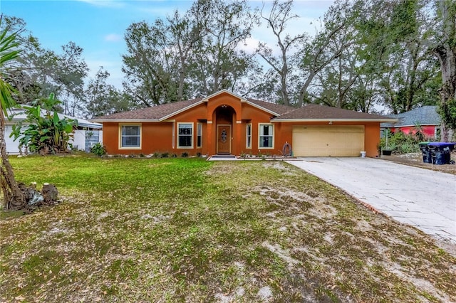 single story home featuring a garage and a front yard