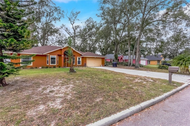 single story home with a garage and a front lawn