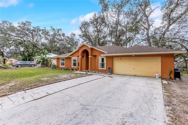 single story home with a garage and a front yard