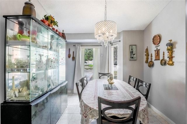 dining area with a notable chandelier and light tile patterned floors