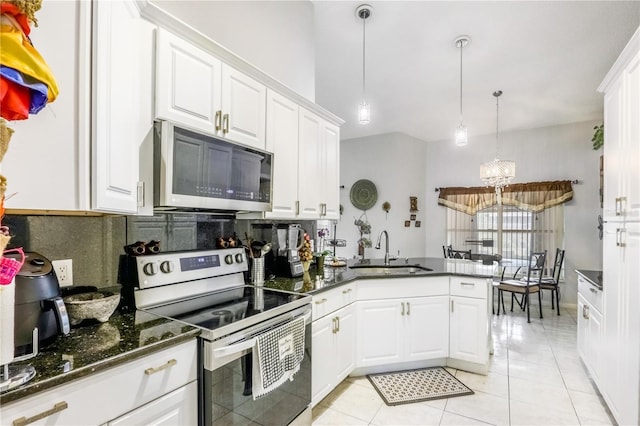 kitchen featuring white cabinetry, sink, kitchen peninsula, and appliances with stainless steel finishes