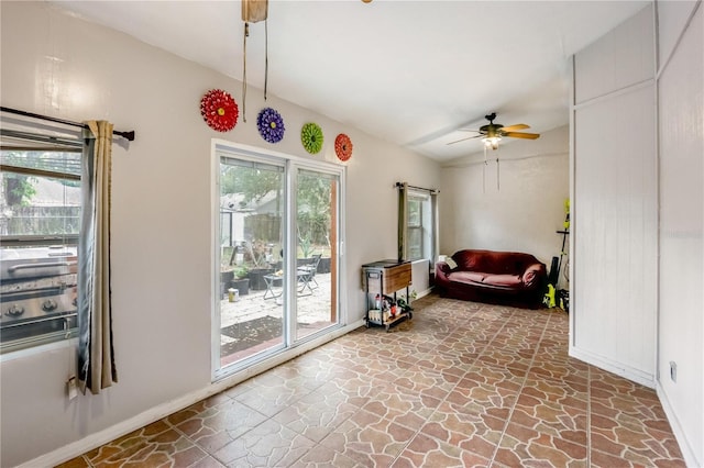 sitting room featuring vaulted ceiling, ceiling fan, and plenty of natural light