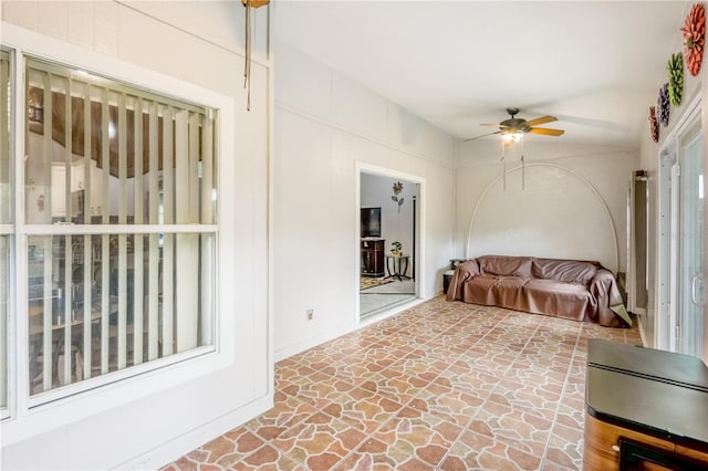 interior space with ceiling fan