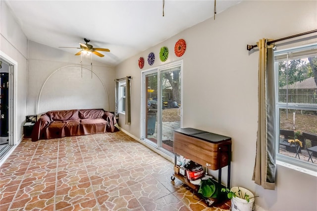 interior space with ceiling fan