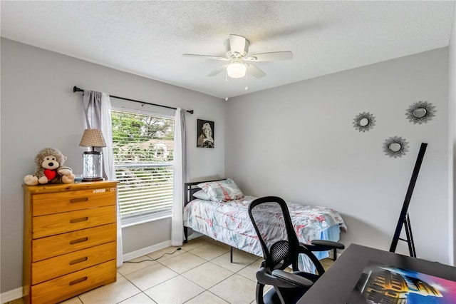 bedroom featuring ceiling fan, a textured ceiling, and light tile patterned flooring