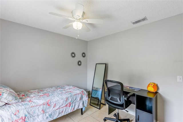 bedroom with ceiling fan, a textured ceiling, and light tile patterned floors