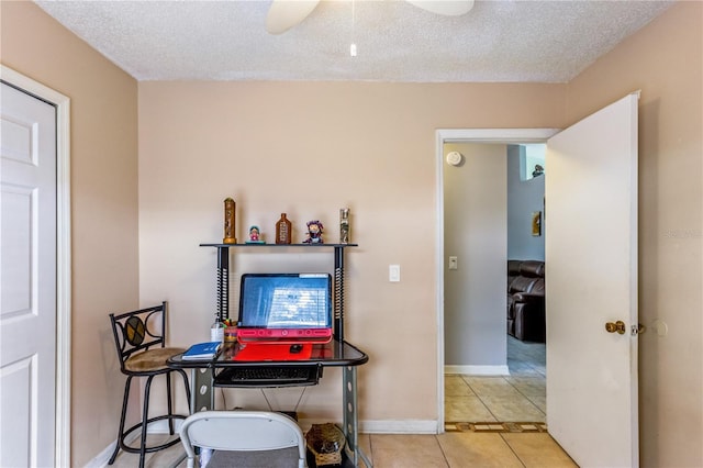 dining room featuring ceiling fan, a textured ceiling, and light tile patterned flooring