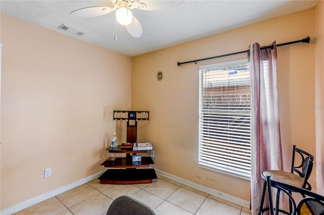 interior space featuring a textured ceiling and ceiling fan