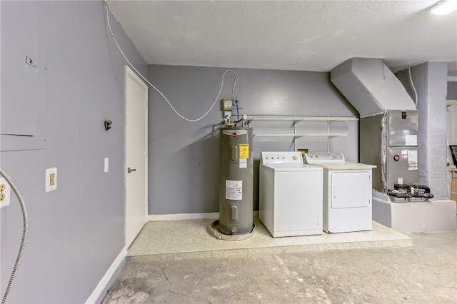 laundry room featuring water heater, washing machine and clothes dryer, and a textured ceiling