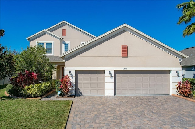 view of front of house with a garage and a front yard