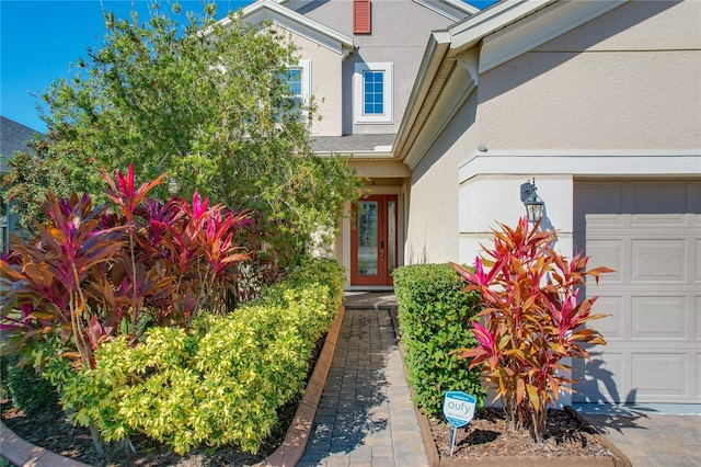 doorway to property with a garage