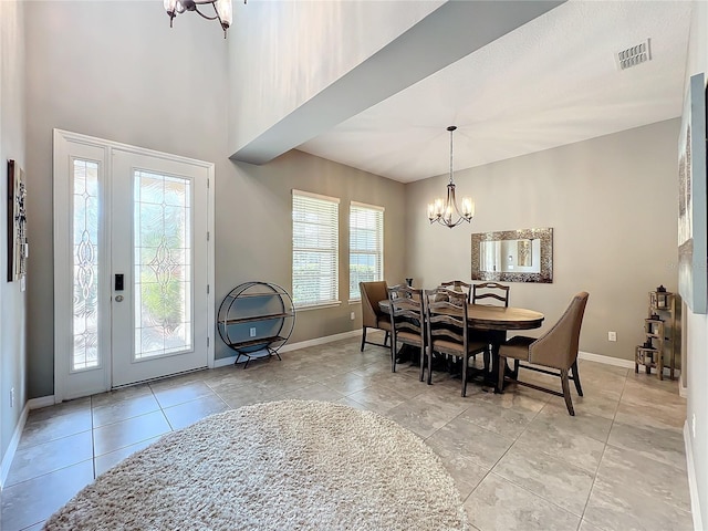 tiled dining room featuring a chandelier