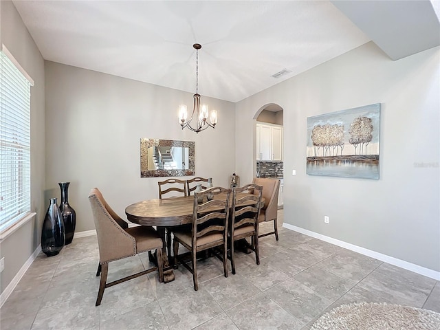 dining space with a notable chandelier