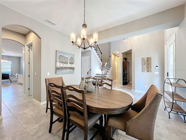 dining room with an inviting chandelier and light tile patterned flooring