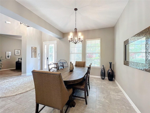 dining room with an inviting chandelier, light tile patterned floors, and a wealth of natural light