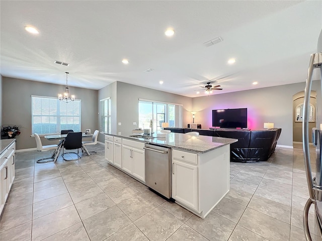 kitchen featuring dishwasher, a kitchen island with sink, white cabinetry, light stone counters, and decorative light fixtures