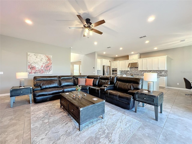 living room featuring sink and ceiling fan