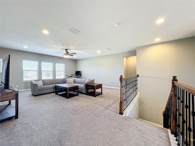 living room featuring light carpet and ceiling fan