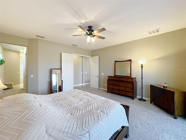 bedroom featuring light colored carpet and ceiling fan