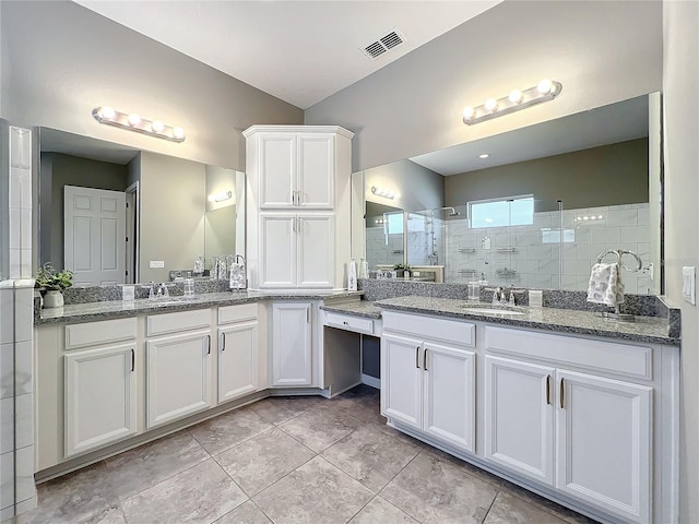 bathroom featuring vanity, an enclosed shower, and tile patterned floors