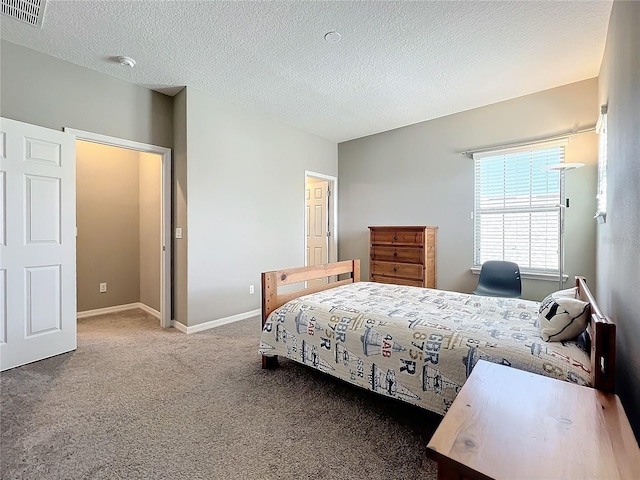 carpeted bedroom featuring a textured ceiling